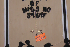Artwork - shows silhouettes of people in front of door that is marked OPEN and titled Museum of Missing Stuff